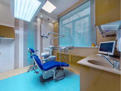 A clean, modern dental clinic room featuring a blue patient chair, reflecting the need for expert fort lauderdale commercial plumbing and routine Sewer Line Inspections for medical practices.