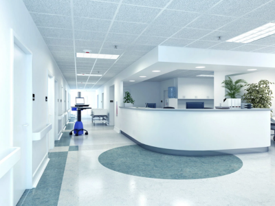 A clean, modern hospital reception area and hallway, representing the need for expert fort lauderdale commercial plumbing and proactive Sewer Line Inspections to maintain sanitary healthcare standards.